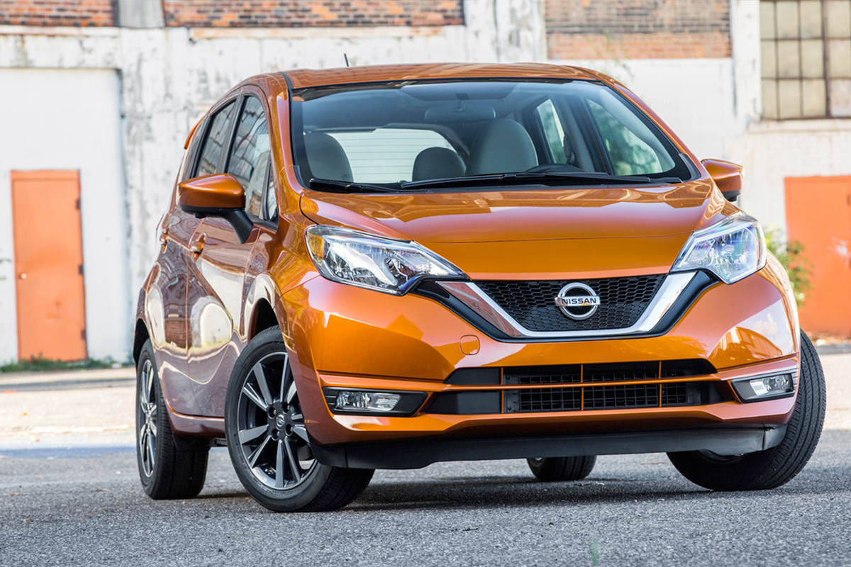 a metallic orange nissan parked on an industrial estate