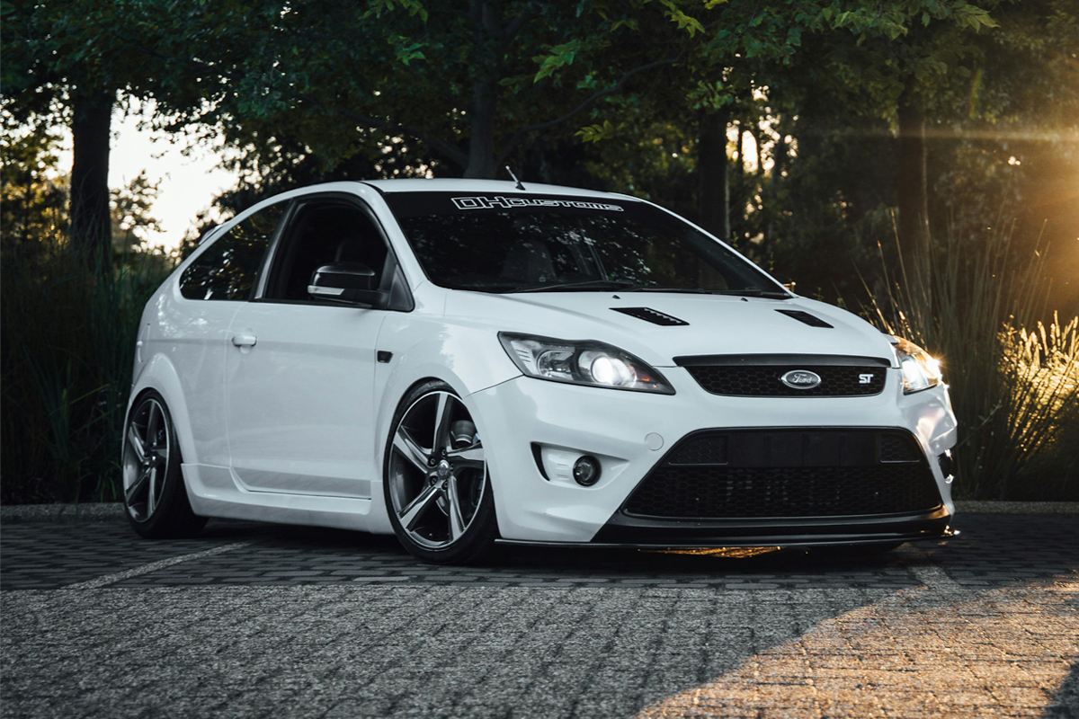 a white and black ford focus parked on a driveway
