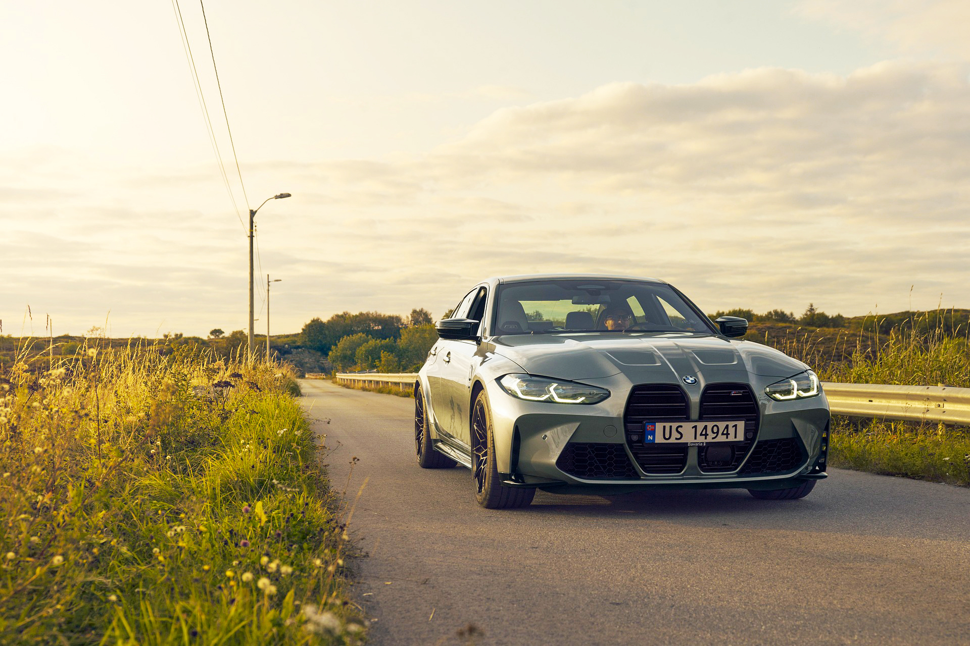 bmw driving on a country road