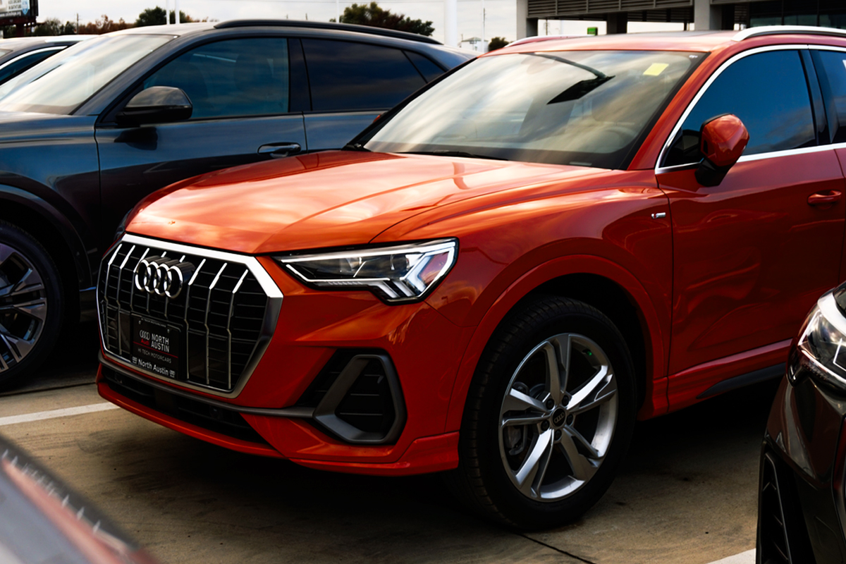 Orange Audi SUV in a public car park