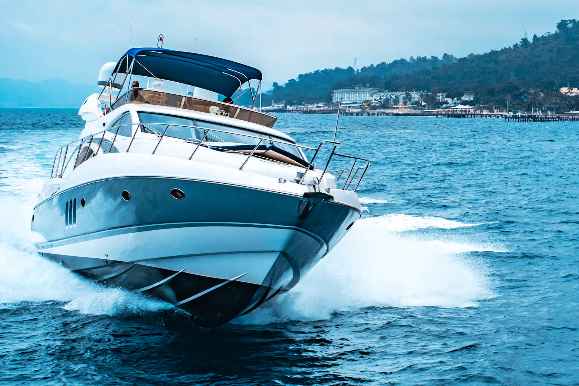 Yacht cruising at full speed off the coast
